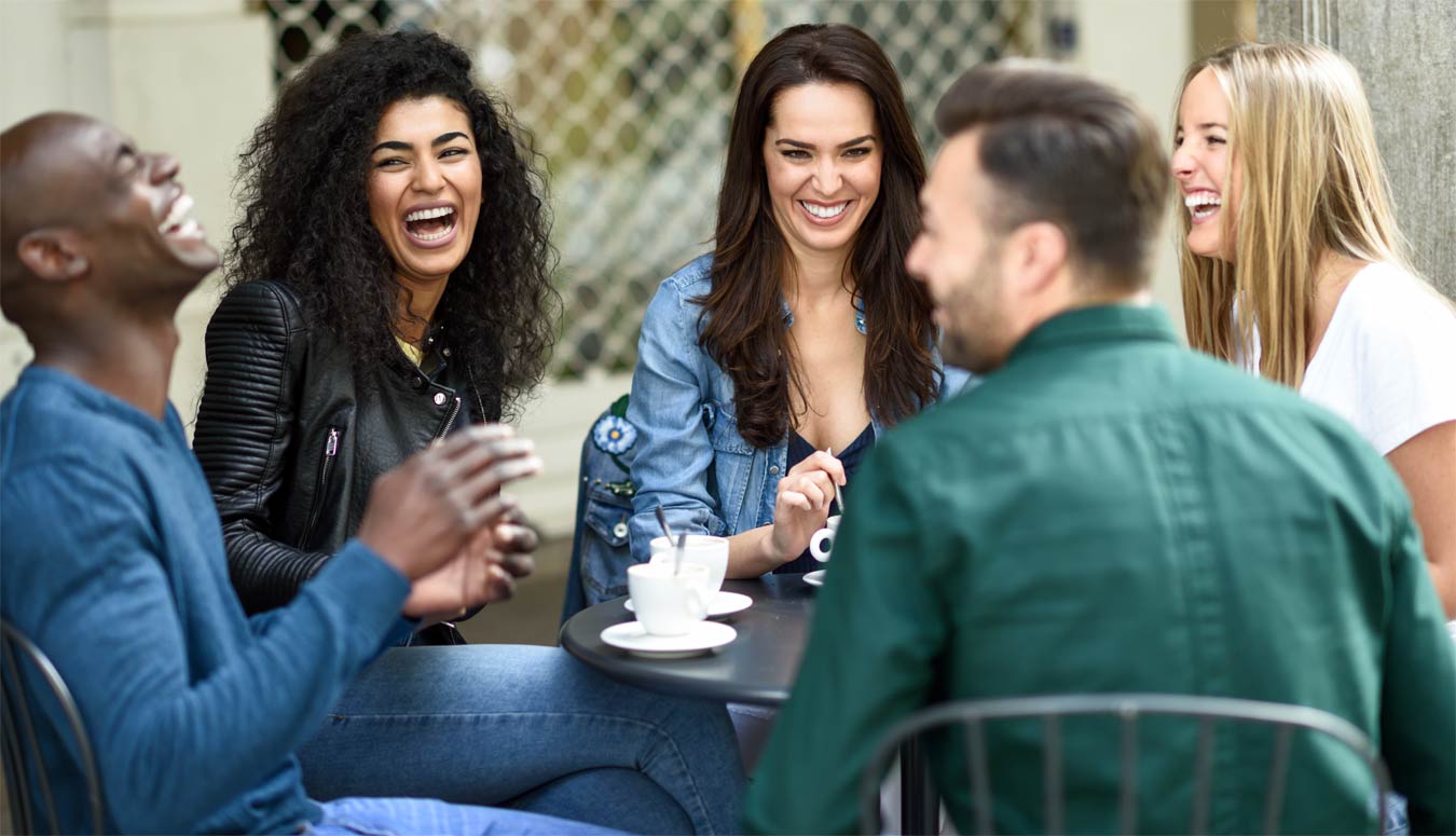 goodencenter-photo-of--Three-women-and-two-men-at-cafe,-talking,-laughing-and-enjoying-their-time